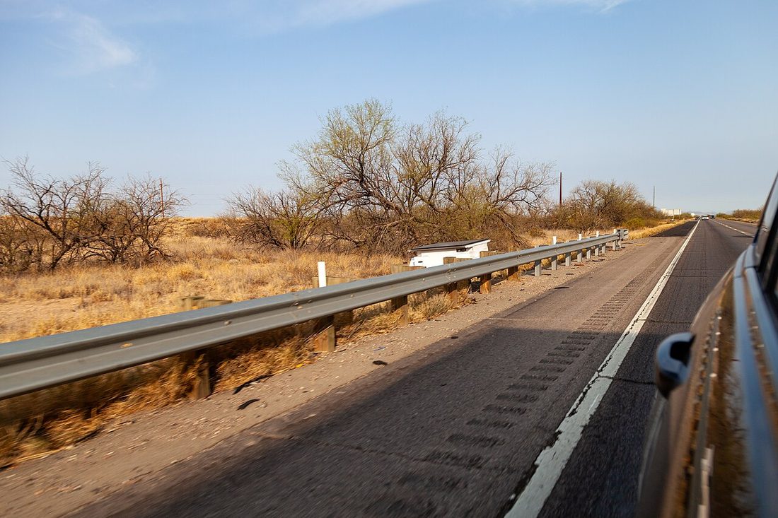 An automated license plate reader mounted over an interstate highway